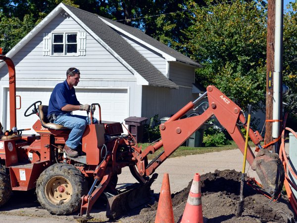 Hamilton employee burying fiber.